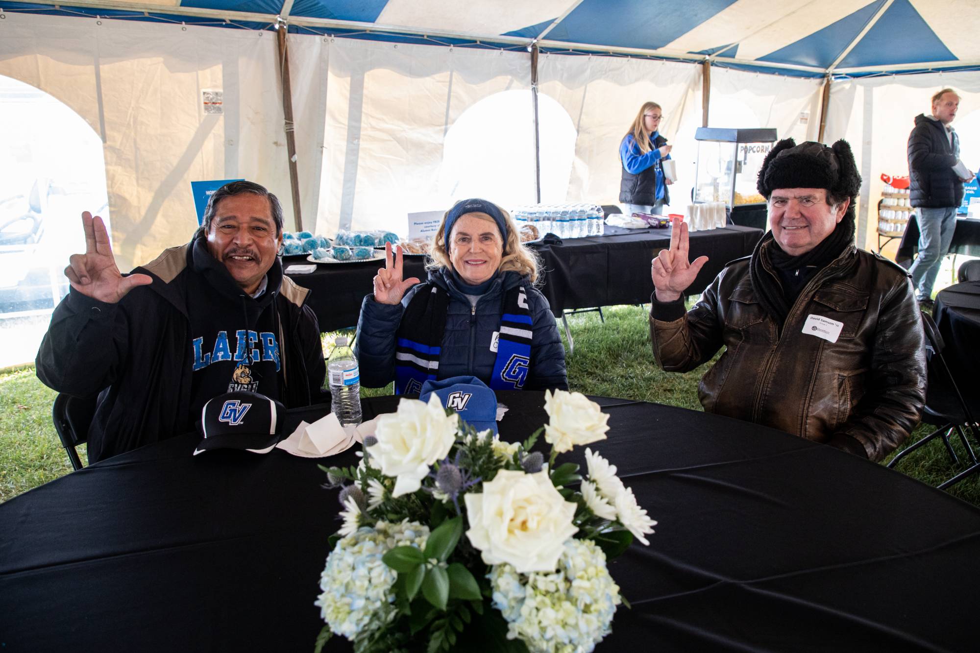 Three alums at the alumni tailgate